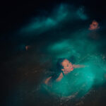 Couple swimming in the Luminous Lagoon in Jamaica